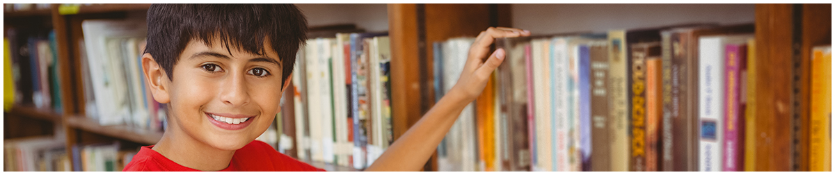 Smiling male student in a library