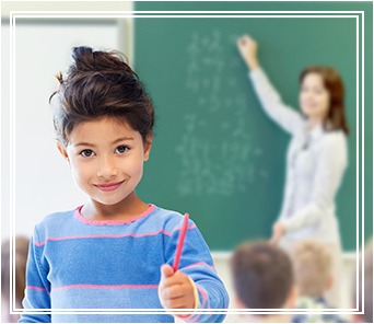 Student holding up a pen in a classroom