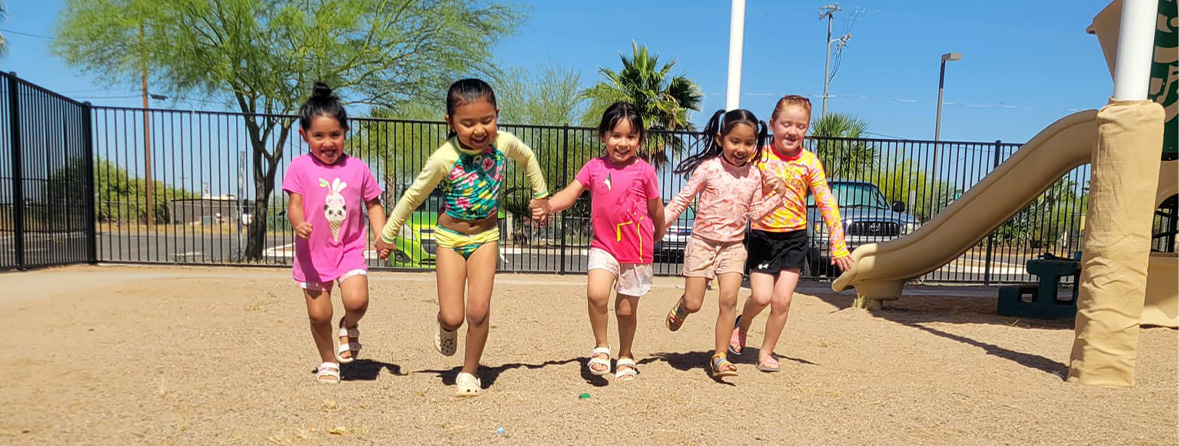 Four students running outside